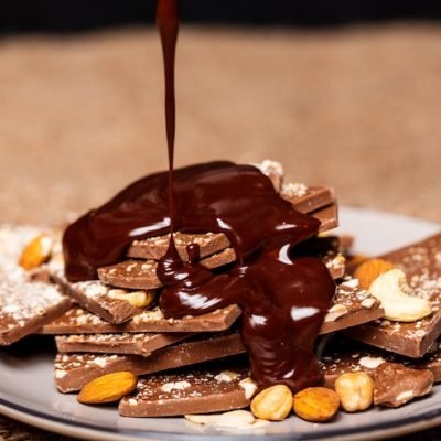 hot-chocolate-pouring-candies-white-plate-sackcloth_176420-7451